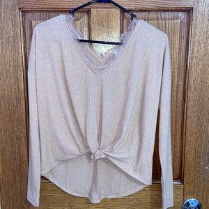 High low long sleeve with tie and lace neckline.